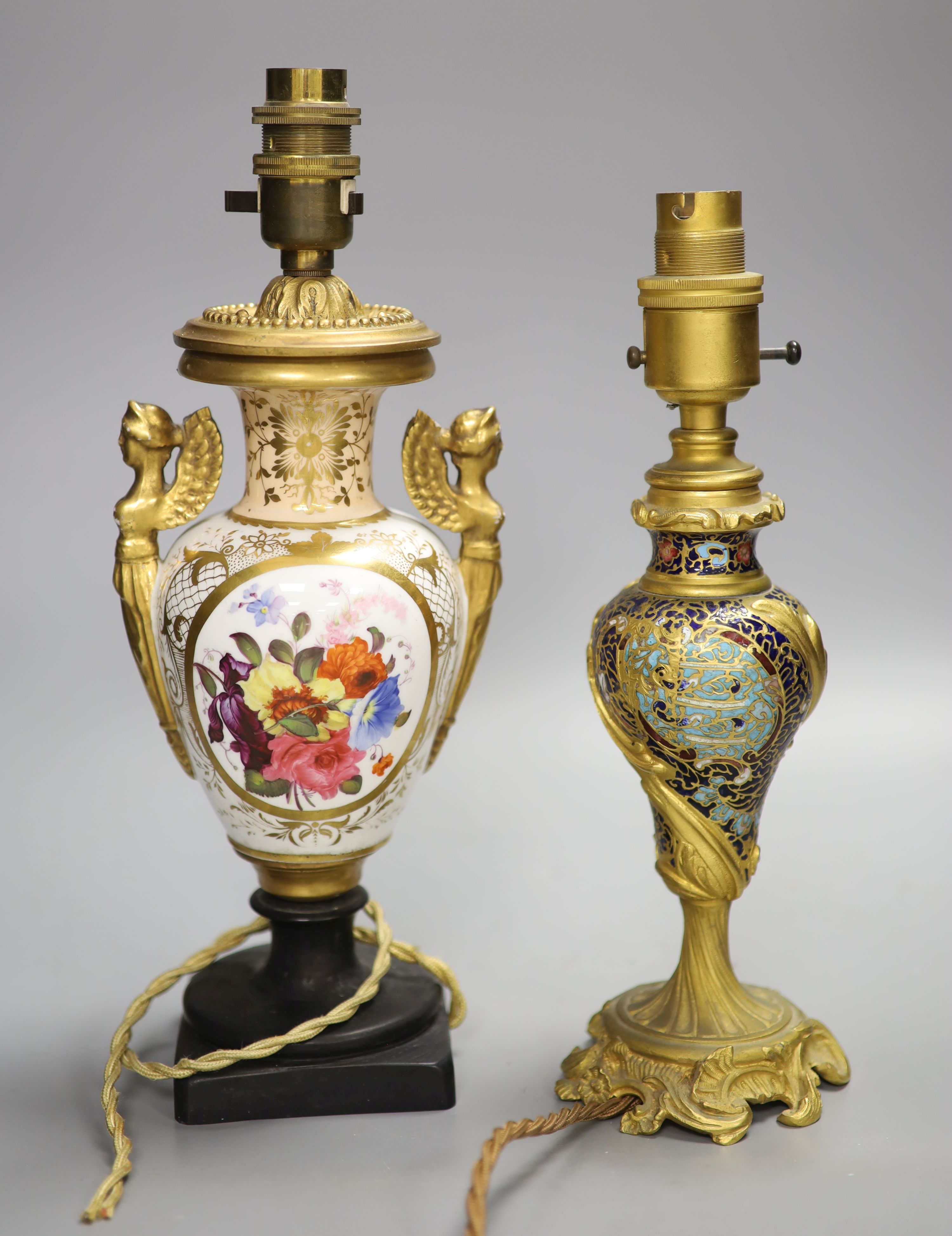 A Rococo revival champleve and ormolu converted table lamp, together with a floral painted porcelain table lamp, overall height 31cm